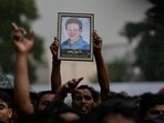 A fan holds a photograph of the popular Bollywood singer and composer Zubeen Garg during the homage ceremony in Guwahati.