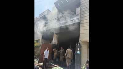 Fire brigade personnel after dousing the blaze at the building near Bharat Nagar Chowk petrol pump in Ludhiana on Wednesday. (HT Photo) Fire brigade personnel after dousing the blaze at the building near Bharat Nagar Chowk petrol pump in Ludhiana on Wednesday. (HT Photo)