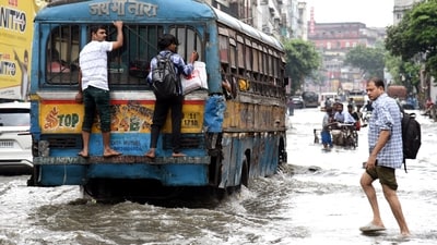 Commuters wade through a waterlogged road, caused by heavy rainfall, in Kolkata on Tuesday. (Debajyoti Chakraborty/ANI) Commuters wade through a waterlogged road, caused by heavy rainfall, in Kolkata on Tuesday. (Debajyoti Chakraborty/ANI)
