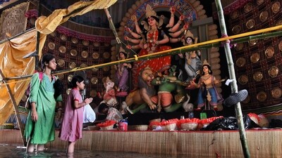 A Durga Puja pandal gets waterlogged after heavy rainfall in Kolkata, with visitors wading to see the idols. (Sudipta Banerjee/ANI) A Durga Puja pandal gets waterlogged after heavy rainfall in Kolkata, with visitors wading to see the idols. (Sudipta Banerjee/ANI)
