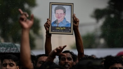 A fan holds a photograph of the popular Bollywood singer and composer Zubeen Garg during the homage ceremony in Guwahati. (AP)