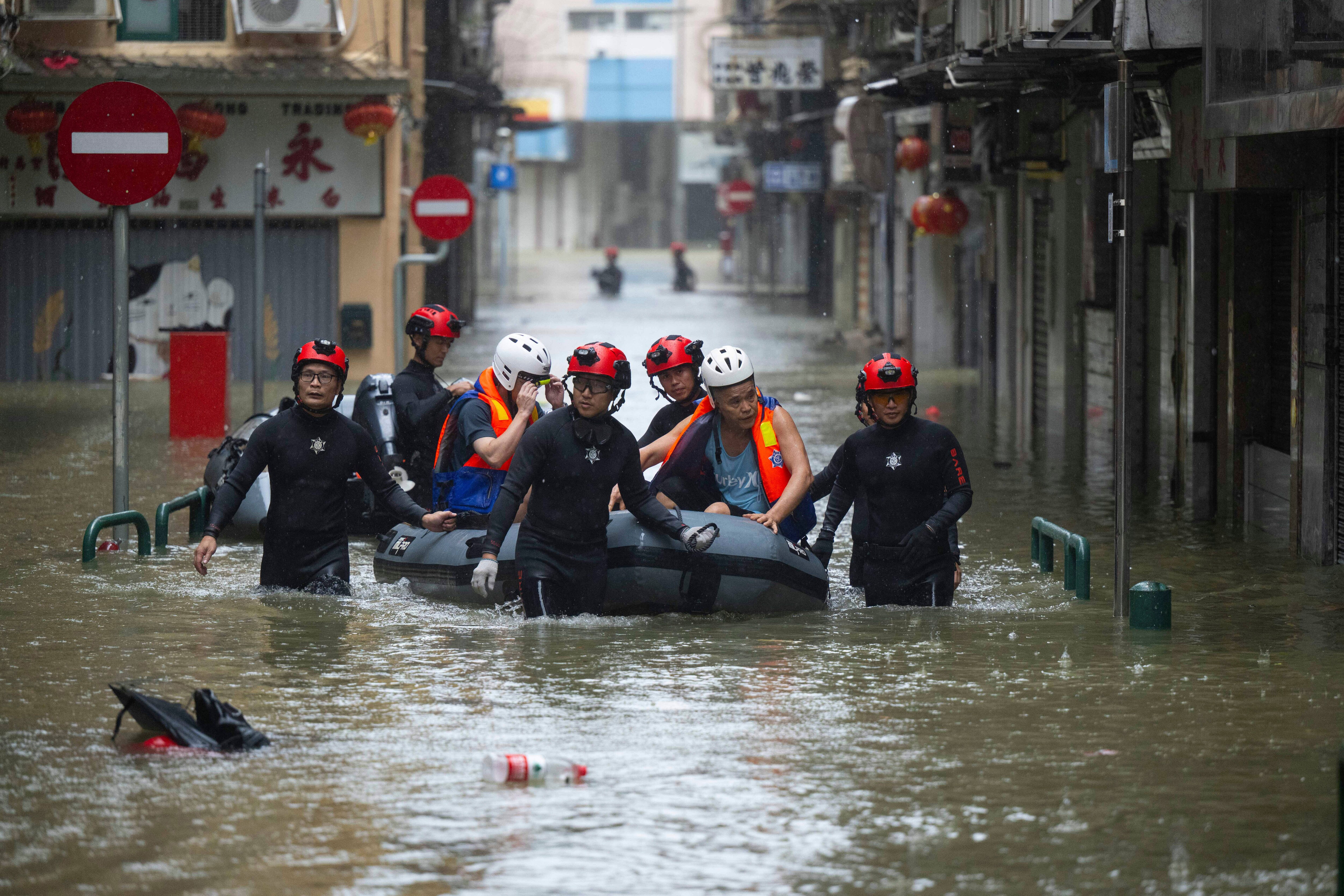 In this photo released by Xinhua News Agency, members from the local customs authority help stranded citizens to evacuate from an inundated street as Super typhoon Ragasa past nearby Macao in southern China, Sept. 24, 2025. (Cheong Kam Ka/Xinhua via AP) (AP)