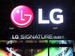 Attendees watch a display of LG Signature T transparent 4K OLED televisions at CES 2024, an annual consumer electronics trade show, in Las Vegas, Nevada.