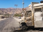 Charred remains of a vehicle lie in the aftermath of violent clashes between demonstrators and police during a protest demanding statehood for Ladakh, outside the BJP headquarters building, in Leh, Thursday, Sept. 25, 2025.