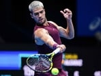 Spain's Carlos Alcaraz hits a return against Argentina's Sebastian Baez during their men's singles round-of-32 match at the ATP Japan Open tennis tournament in Tokyo on September 25, 2025. (Photo by Yuichi YAMAZAKI / AFP)