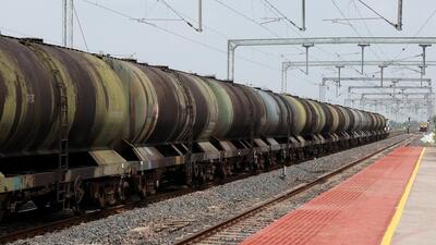 A oil tanker train moves near a railway station on the outskirts of Ahmedabad, India. (REUTERS)