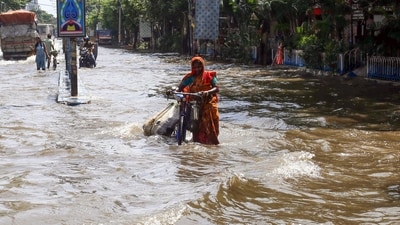 Kolkata: A woman wades through the waterlogged street of south Kolkata due to heavy rainfall, in Kolkata on Wednesday. (ANI Photo) (Saikat Paul) Kolkata: A woman wades through the waterlogged street of south Kolkata due to heavy rainfall, in Kolkata on Wednesday. (ANI Photo) (Saikat Paul)