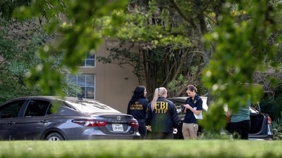 Law enforcement personnel gather outside the Fairview, Texas home of Joshua Jahn, the suspected gunman in a fatal shooting (REUTERS)