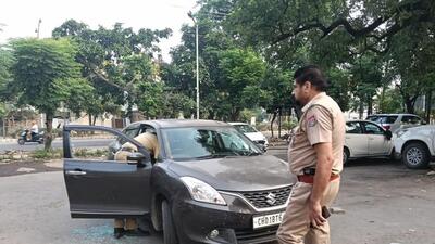 Police at the crime spot after the two motorcycle-borne attackers shot at a gym owner while he was seated in his car in the parking of the Phase 2 market in Mohali on Thursday morning. (HT Photo) Police at the crime spot after the two motorcycle-borne attackers shot at a gym owner while he was seated in his car in the parking of the Phase 2 market in Mohali on Thursday morning. (HT Photo)