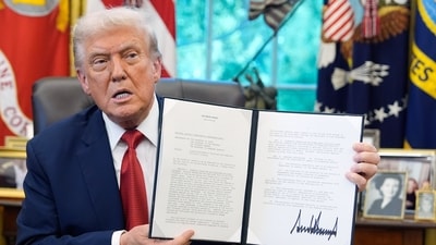 President Donald Trump holds a signed presidential memorandum in the Oval Office at the White House. (AP Photo) President Donald Trump holds a signed presidential memorandum in the Oval Office at the White House. (AP Photo)