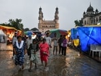 People wade through water after a heavy downpour at Chaar Minar, in Hyderabad’s Old City. People wade through water after a heavy downpour at Chaar Minar, in Hyderabad’s Old City.