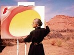 American artist Georgia O'Keeffe (1887 - 1986) stands at an easel outdoors, adjusting a canvas from her 'Pelvis Series- Red With Yellow,' in Albuquerque, New Mexico, 1960. In Desai’s novel, Ilan calls O’Keeffe a phoney. (Tony Vaccaro/Getty Images)