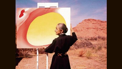 American artist Georgia O'Keeffe (1887 - 1986) stands at an easel outdoors, adjusting a canvas from her 'Pelvis Series- Red With Yellow,' in Albuquerque, New Mexico, 1960. In Desai’s novel, Ilan calls O’Keeffe a phoney. (Tony Vaccaro/Getty Images) American artist Georgia O'Keeffe (1887 - 1986) stands at an easel outdoors, adjusting a canvas from her 'Pelvis Series- Red With Yellow,' in Albuquerque, New Mexico, 1960. In Desai’s novel, Ilan calls O’Keeffe a phoney. (Tony Vaccaro/Getty Images)