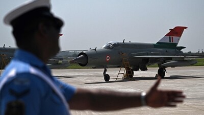 An Indian air force official signals a MiG-21 bison fighter jet at the tarmac at Chandigarh airforce station on Wednesday. (Arun Sankar/AFP) An Indian air force official signals a MiG-21 bison fighter jet at the tarmac at Chandigarh airforce station on Wednesday. (Arun Sankar/AFP)