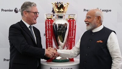 Indian PM Narendra Modi and his British PM Keir Starmer strike a pose with the Premier League football championship trophy during Modi's recent visit to UK. (X/@NarendraModi)