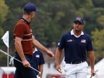 Team Europe's Justin Rose and Team USA's Bryson DeChambeau argue on the 15th green. 