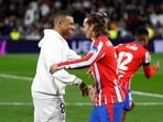 Real Madrid's Kylian Mbappe shakes hands with Atletico Madrid's Antoine Griezmann.