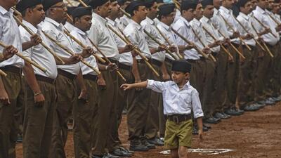A boy walks past RSS volunteers in Pune. (Pratham Gokhale/HT File Photo) A boy walks past RSS volunteers in Pune. (Pratham Gokhale/HT File Photo)
