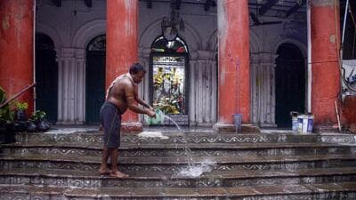 A man cleans the stairs at Bonedi Bari ahead of Durga Puja festival, in Kolkata on Thursday. (ANI) A man cleans the stairs at Bonedi Bari ahead of Durga Puja festival, in Kolkata on Thursday. (ANI)