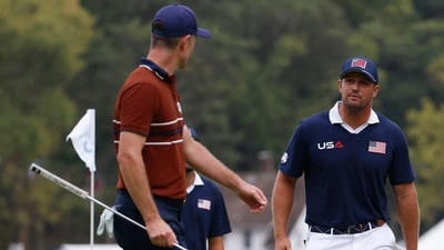 Team Europe's Justin Rose and Team USA's Bryson DeChambeau argue on the 15th green. (Reuters)