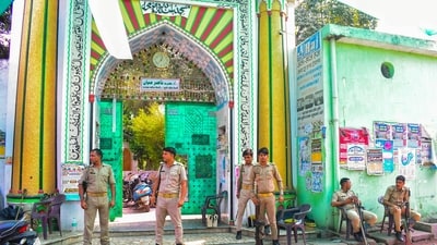 Police personnel stand guard outside a dargah, a day after clashes between police and locals, in Bareilly, Uttar Pradesh, Saturday, Sept. 27, 2025. (PTI)