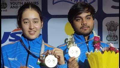 Rashmika Sahgal and Kapil pose with their air pistol mixed team gold medal at the ISSF Junior World Cup in Delhi on Saturday. (HT Photo)