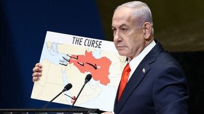 Israeli Prime Minister Benjamin Netanyahu holds a map as he speaks during the General Debate of the United Nations General Assembly at UN headquarters in New York City on September 26 (AFP)