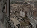 A view through a destroyed window shows the site of heavily damaged residential buildings following a Russian air attack on the outskirts of Kyiv, on September 28, 2025, A view through a destroyed window shows the site of heavily damaged residential buildings following a Russian air attack on the outskirts of Kyiv, on September 28, 2025,