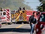Firefighters and first responders work along a road while responding to the scene of a shooting at a church in Grand Blanc, Michigan, on September 28, 2025. Firefighters and first responders work along a road while responding to the scene of a shooting at a church in Grand Blanc, Michigan, on September 28, 2025.
