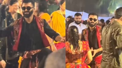 The man is seen wearing a black kurta and dhoti while playing garba in the rain. (@parth_suri/Instagram) The man is seen wearing a black kurta and dhoti while playing garba in the rain. (@parth_suri/Instagram)