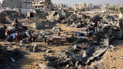 Displaced Palestinians check what remains of their tents, following an overnight Israeli strike that levelled a building and damaged the surrounding temporary shelters, in the Rimal neighbourhood of Gaza City. (Omar al-Qattaa/AFP) Displaced Palestinians check what remains of their tents, following an overnight Israeli strike that levelled a building and damaged the surrounding temporary shelters, in the Rimal neighbourhood of Gaza City. (Omar al-Qattaa/AFP)