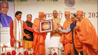 Gujarat and Maharashtra governor Acharya Devvrat presents Saraswati Samman 2024 to Mahamahopadhyaya Bhadreshdas Swami at BAPS Swaminarayan Mandir, Shahibaug, Ahmedabad, on Sunday. (HT Photo) Gujarat and Maharashtra governor Acharya Devvrat presents Saraswati Samman 2024 to Mahamahopadhyaya Bhadreshdas Swami at BAPS Swaminarayan Mandir, Shahibaug, Ahmedabad, on Sunday. (HT Photo)