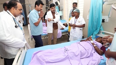 Tamil Nadu Deputy Chief Minister Udhayanidhi Stalin talks to an injured person being treated at a hospital, after a stampede at actor and TVK chief Vijay's rally on Saturday. (PTI )