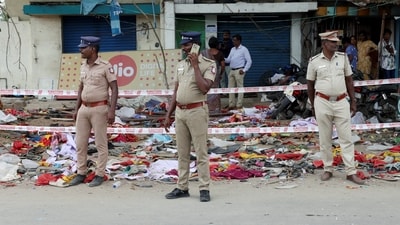 Police officers stand guard at the site following a stampede incident during a rally held by Tamilaga Vettri Kazhagam party, in Karur district of Tamil Nadu. (Priyanshu Singh/Reuters)