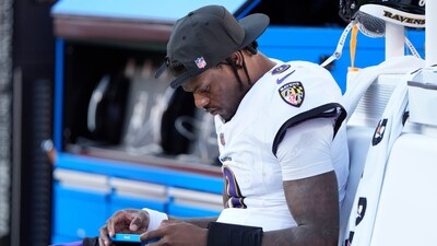 Baltimore Ravens quarterback Lamar Jackson sits on the bench after being replaced by Cooper Rush (AP)