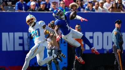 New York Giants wide receiver Malik Nabers (1) reacts as he leaps for a pass against Los Angeles Chargers cornerback Cam Hart (20) (AP) New York Giants wide receiver Malik Nabers (1) reacts as he leaps for a pass against Los Angeles Chargers cornerback Cam Hart (20) (AP)