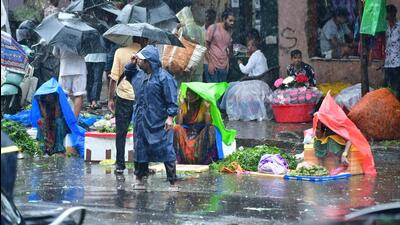People walk through a water-logged street in Dadar. (Bhushan Koyande/HT Photo) People walk through a water-logged street in Dadar. (Bhushan Koyande/HT Photo)