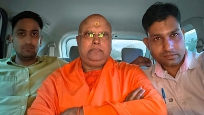 Self-styled godman Chaitanyananda Saraswati with police personnel after his arrest, in Agra. (ANI) Self-styled godman Chaitanyananda Saraswati with police personnel after his arrest, in Agra. (ANI)