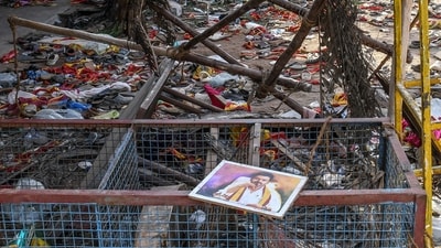 A portrait of actor-turned-politician Vijay is seen near the scattered shoes after a stampede that broke out last evening during his political rally in the Karur district. (AFP)