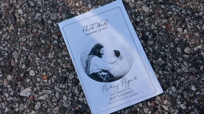 The day's program for the church service is seen fallen on the ground near a family reunification area in Grand Blanc Trillium following the shooting at a the church on Sunday. (Jeff Kowalsky/AFP) The day's program for the church service is seen fallen on the ground near a family reunification area in Grand Blanc Trillium following the shooting at a the church on Sunday. (Jeff Kowalsky/AFP)