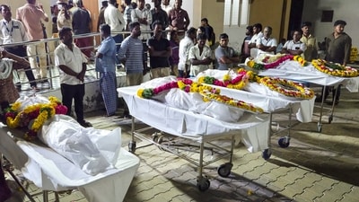 People stand near mortal remains of victims, who died after a stampede broke out at actor and TVK chief Vijay's rally on Saturday, at the government hospital, in Karur. (PTI ) People stand near mortal remains of victims, who died after a stampede broke out at actor and TVK chief Vijay's rally on Saturday, at the government hospital, in Karur. (PTI )