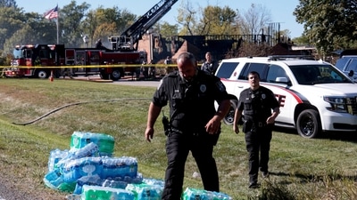 Law enforcement officials maintain vigilance outside the church in Michigan that was attacked on Sunday. (Rebecca Cook/REUTERS)