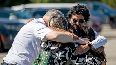 A family emotionally reunites at the Trillium Theater located across the street from the site of a shooting and fire at the Church of Jesus Christ of Latter-day Saints on September 28, 2025 in Grand Blanc, Michigan. (Getty Images via AFP) A family emotionally reunites at the Trillium Theater located across the street from the site of a shooting and fire at the Church of Jesus Christ of Latter-day Saints on September 28, 2025 in Grand Blanc, Michigan. (Getty Images via AFP)