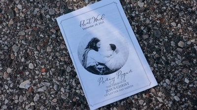 The day's program for the church service is seen on the ground near the family reunification area outside of the NCG Cinema - Grand Blanc Trillium following a shooting a shooting at a church in Grand Blanc, Michigan, on September 28, 2025. (AFP) The day's program for the church service is seen on the ground near the family reunification area outside of the NCG Cinema - Grand Blanc Trillium following a shooting a shooting at a church in Grand Blanc, Michigan, on September 28, 2025. (AFP)