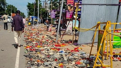 Footwear and other belongings of people, who attended the rally of actor and TVK chief Vijay, lie on a road in the aftermath of a stampede during the rally in Karur. (PTI)