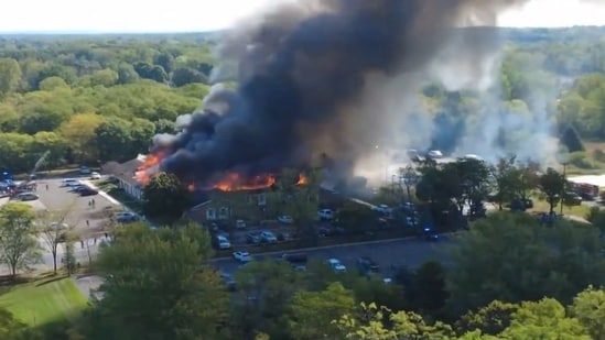 A frame grab from a drone footage shows smoke rising from the Mormon church in the US state of Michigan that was set on fire on Sunday.(AFP)