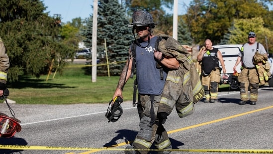 Firegfighters walk away from the scene of a shooting at the Church of Jesus Christ of Latter-day Saints, in Grand Blanc, Michigan, U.S., September 28, 2025. REUTERS/Rebecca Cook(REUTERS)