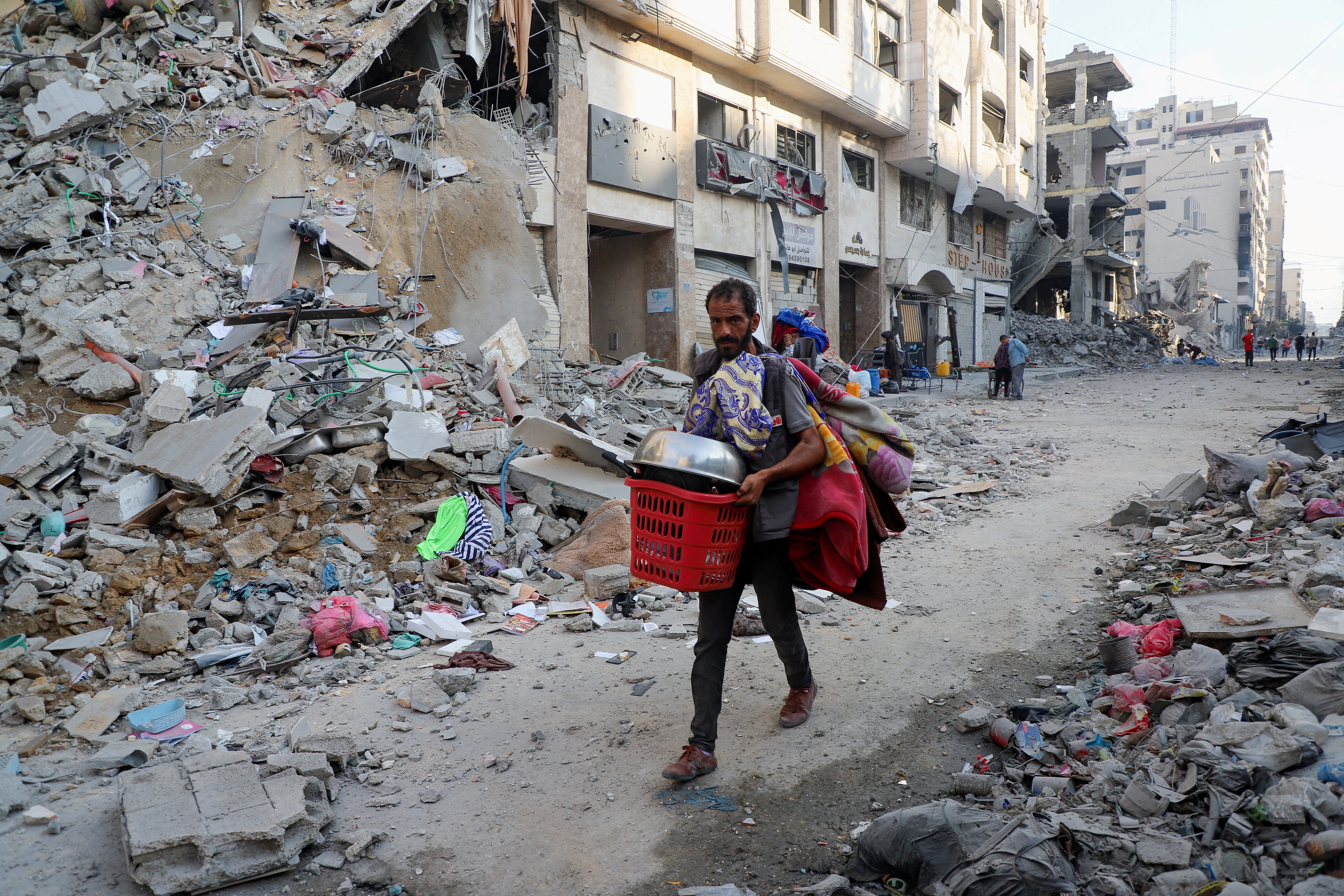 A Palestinian man carries his belongings during an Israeli military operation, after residents were ordered to evacuate Gaza City, on September 29, 2025. (Reuters)