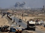 Smoke rises during an Israeli military operation as displaced Palestinians flee Gaza City, in the central Gaza Strip, on September 30, 2025.