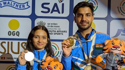 Isha Taksale and Himanshu pose with their 10m air rifle mixed team gold medals at the ISSF Junior World Cup in Delhi on Tuesday. (NRAI) Isha Taksale and Himanshu pose with their 10m air rifle mixed team gold medals at the ISSF Junior World Cup in Delhi on Tuesday. (NRAI)